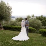 Garden villa wedding Italy. Wedding couple admiring the view over Lake Trasimeno