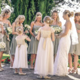 Bride, bridesmaids and flower girl chat before the ceremony starts