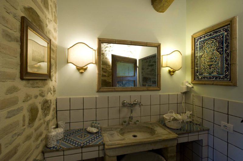 View of the bathroom with the marble sink, mirror, hairdryer and welcome set of soap and shampoo. wedding tuscany villa