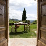 Outside wooden table and chairs for an outdoor meal in the lovely garden. wedding tuscany villa