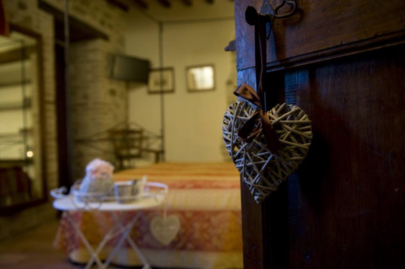 Wooden antique door showing the entrance to one of the bedrooms. wedding villa tuscany