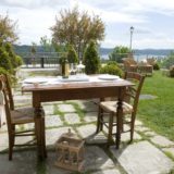 Wooden table and chairs for an intimate lunch overlooking Lake Trasimeno. wedding villa tuscany