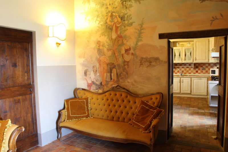Antique sofa and original fresco witnessing how unique the villa is.villa wedding Italy