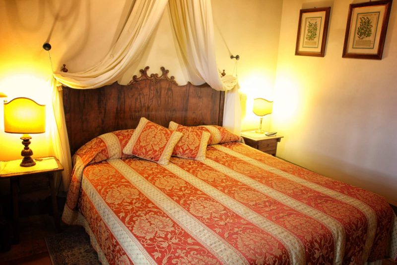 One of the bedrooms in Villa 1, antique bed witnessing the originality of the villa.villa wedding Italy