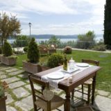 Lovely outdoor furniture enjoying the villa's exclusive garden and amazing view over Lake Trasimeno.villa wedding Italy