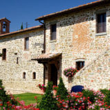 Side view of Wedding villas Italy San Crispolto and outside garden and blooming flowers.