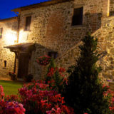 Side view of the Exclusive weddings villa Italy and garden at night.