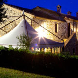 Side view of the Exclusive weddings villa Italy and marquee at night time.
